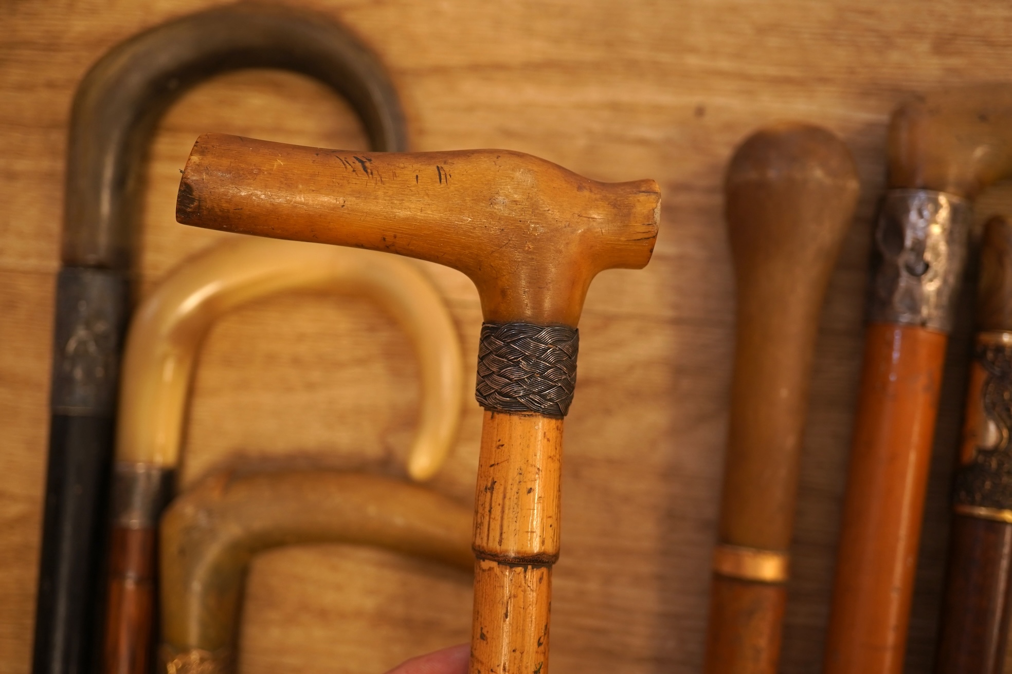 A collection of seven horn handles walking sticks some gold and white metal mounted